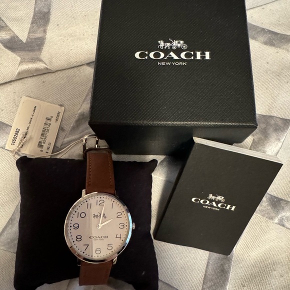 Brand new Coach watch with white face and brown leather strap.